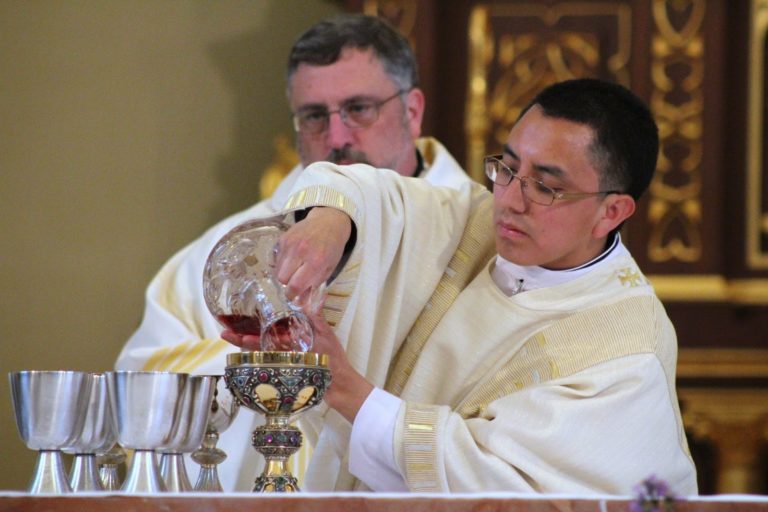 Deacon Basilio Az Cuc pours the wine for the consecration at his transitional diaconate ordination Mass on April 18, 2015. Photo courtesy of Larena Lawson.