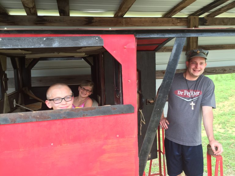 James Dennis is visited by young friends Preston Hans and Kate Hans, who are treated to a ride on the train. Photo courtesy of Melissa Baysinger. 